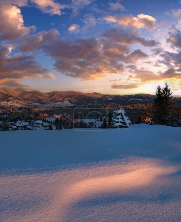 Photo for Alpine village outskirts in last evening sunset sun light. Winter snowy hills and fir trees. High resolution stitch image with great depth of field. - Royalty Free Image