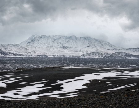Photo for Autumn snowfall in Iceland highlands. Colorful Landmannalaugar mountains under snow cover in autumn, Iceland. Lava fields of volcanic sand in the foreground. - Royalty Free Image