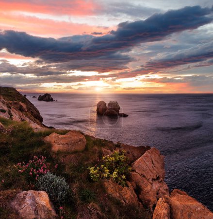 Photo for Sunset blossoming Atlantic Ocean beautiful coastline landscape (Arnia Beach, Biskaya, Cantabria, Spain). Two shots stitch image. - Royalty Free Image