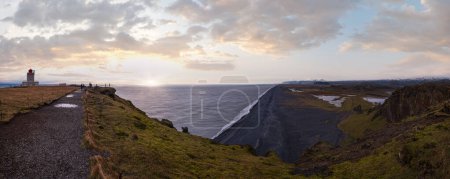 Picturesque autumn evening view to endless ocean  black volcanic sand beach from Dyrholaey Cape Viewpoint, Vik, South Iceland.