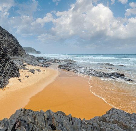 Atlantic ocean storm and Castelejo beach with black schist cliffs (Algarve, Portugal).