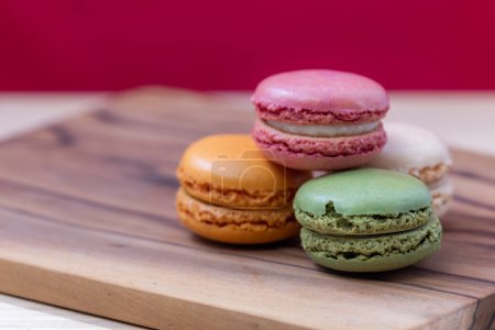 Photo for French Macaroons in bright colors on a wooden platter - Royalty Free Image