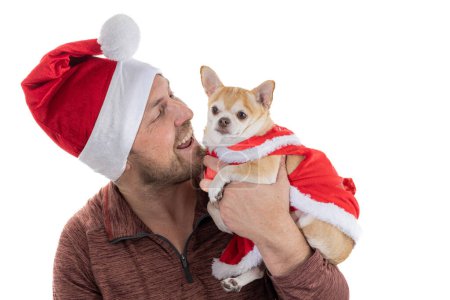 Photo for Man and puppy with christmas hat and dress isolated on a white background - Royalty Free Image