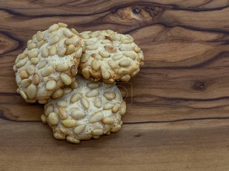 Photo for Close up of a fresh baked italian pignoli cookies on a wooden table - Royalty Free Image