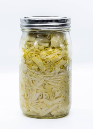 Téléchargez les photos : Wide mouth jar filled with fermented cabbage isolated on a white background - en image libre de droit