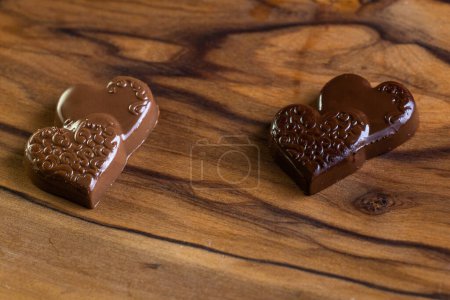Photo for Heart shaped chocolates on a wooden table close up - Royalty Free Image