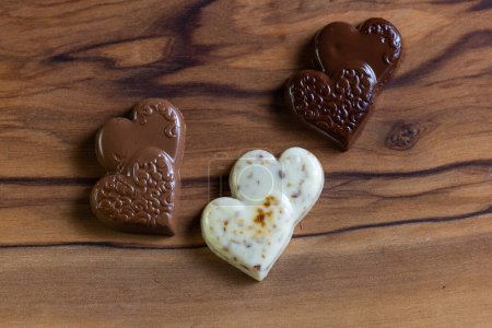 Photo for Heart shaped chocolates on a wooden table close up - Royalty Free Image