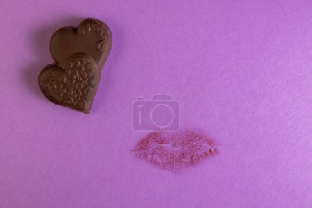 Photo for Concept for a love note sealed with a kiss and heart shaped chocolates - Royalty Free Image