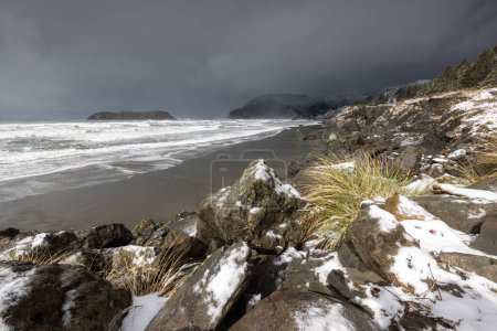 Photo for Myers creek beach just to the side of highway 101 covered in ice and snow after a rare winter storm brought snow to the Southern Oregon coast late February 2023. - Royalty Free Image