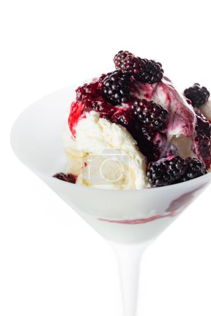 Photo for Fresh wild berries on top of vanilla ice cream isolated on a white background. - Royalty Free Image