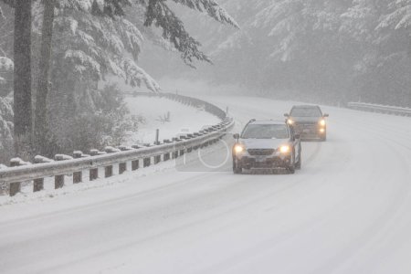 Photo for Passenger vehicles driving on snow covered highway 101 in Southern Oregon, February 2023 - Royalty Free Image