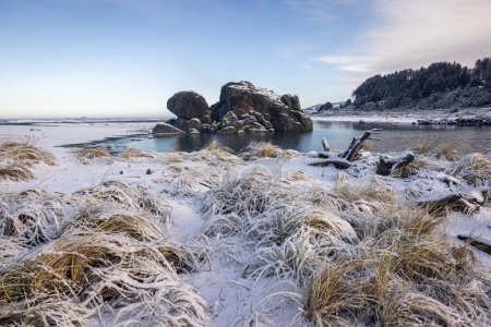 Photo for Popular rock feature in Gold Beach Oregon known as turtle rock covered with snow in a rare winter storm in February 2023 - Royalty Free Image
