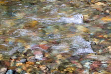 Photo for Naturally colorful river rocks under water in Glacier National Park, Montana - Royalty Free Image