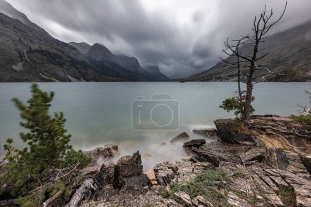 Photo for Stormy weather in glacier National Park viewed from the base of St Mary with choppy water and a very dramatic landscape. - Royalty Free Image