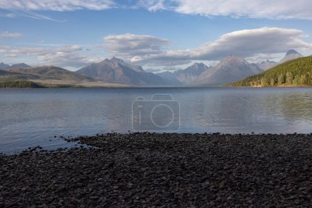 Photo for Peaceful afternoon in glacier Montana from the shores of McDonald Lake and the mountains in the backgroun. - Royalty Free Image