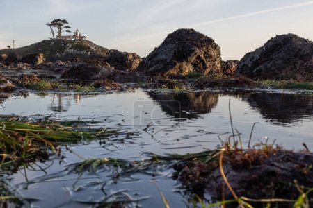 Photo for Beautiful view of the Battery Point Lighthouse seen thru the rocks and puddles with reflections in Crescent City California. - Royalty Free Image