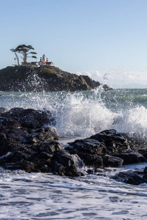 Beautiful view of the Battery Point Lighthouse with waves splashing in the foreground in Crescent City California.