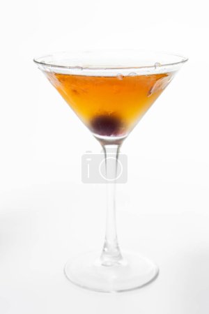 Photo for Chilled Bourbon Manhattan with a Bordeaux cherry over a white background - Royalty Free Image