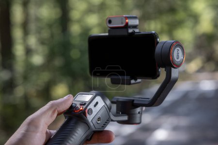 Photo for PROSPECT, OREGON/USA - AMRCH 19: Close up of a hohem MT2 gimbal balancing a phone in a natural forest setting. March 19, National forest in Oregon. - Royalty Free Image