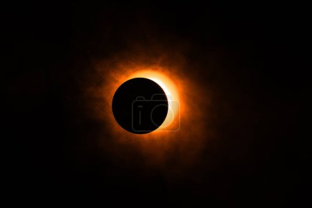 Eclipse image created in a studio using a bright flashlight, a round cap and a can of atmospheric spray for, well, atmosphere. 
