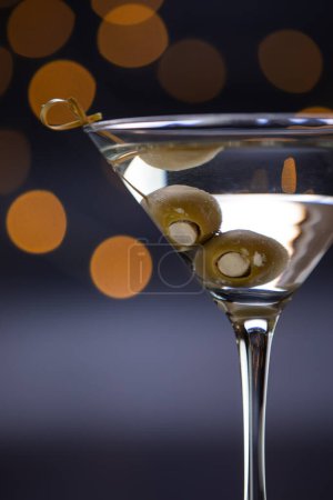 Photo for A martini glass with olives in it. The olives are marinating inside of the drink and the glass is full - Royalty Free Image