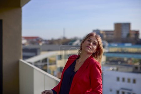 Photo for A woman on the balcony smoking on a sunny day. - Royalty Free Image