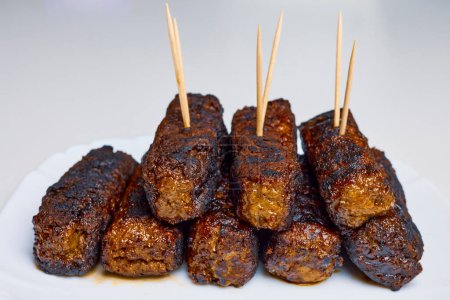 Meat rolls called (mici) on a plate, traditional Romanian food.