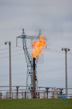 an oil rig with a large burning flame