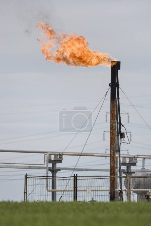an oil rig with a large burning flame