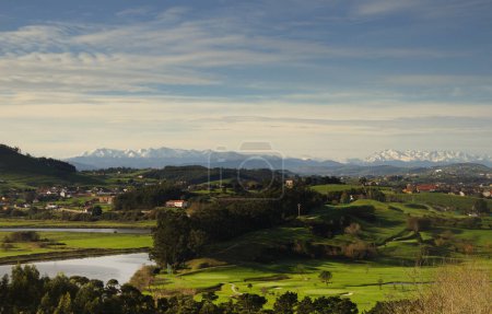 Cantabria, view inland over Liencres area, snow on Picos de Europa mountain range