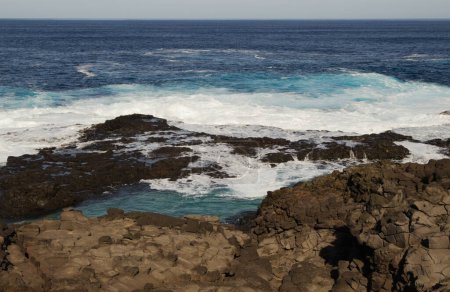 Lanzarote, piscinas de roca Los Charcones bajo acantilados escarpados de la costa noroeste se encuentran en la plataforma construida por antiguos flujos de lava