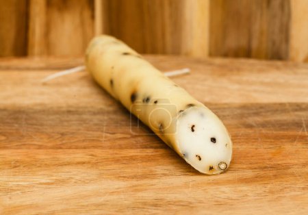 Produce of Spain - stick of hard goat cheese with whole plack peppercorns produced om Fuerteventura