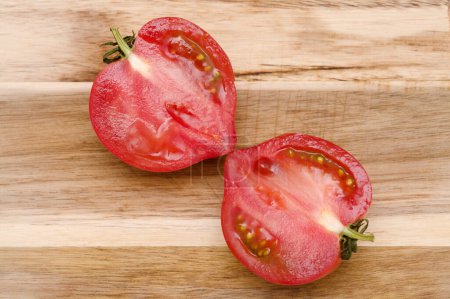 Photo for Round Pink tomato with a nose that produces heart shape when cut in half - Royalty Free Image