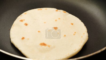 Photo for Making sourdough leavened pita-like flatbread on dry frying pan - Royalty Free Image
