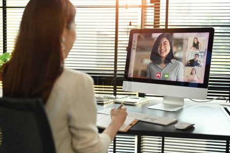 Millennial female manager communicating by video conference on computer. Distant webinar, online negotiations concept.