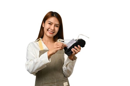 Cheerful female waitress holding credit card and payment terminal on white background. Electronic money, contactless payment concept.