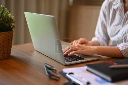 Photo for Cropped shot of businesswoman hands typing on laptop keyboard searching information on internet. - Royalty Free Image