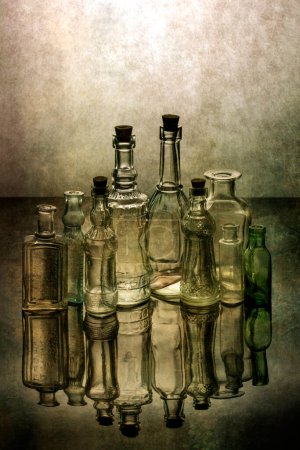 Still life with old glass bottles with reflection