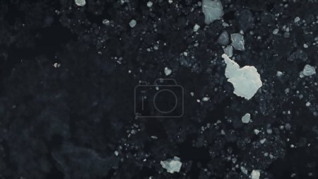 Antarctica drone aerial flight. Top down view to the ice ocean. Fast time lapse overview the dark deep polar ocean water with pieces of ice, snow and icebergs. Harsh environment. Permafrost. 4k