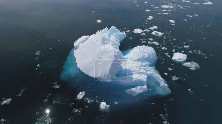 Foto de Close-up Iceberg Floating In Antarctica Ocean. Vuelo aéreo sobre el Polo Sur. Drone Overview of Massive Glacier In Clear Ocean (en inglés). Reflejo solar en agua pura. Naturaleza polar salvaje. Filmación 4k
. - Imagen libre de derechos