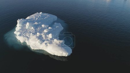 Iceberg Float in Clear Water Ocean Drone Above View. Huge Ice Melt in Ocean, Global Climate Change Concept Pan Right Flight. Winter Polar Glacier Landscape. Footage Shot in 4K UHD