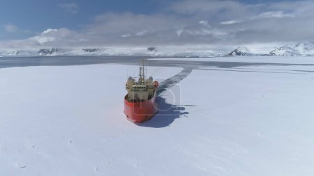 Antarctica Icebreaker Vessel Front Aerial View. Laurence M. Gould Research Boat Break Through Southern Ocean Glacier at Frozen Polar Coast Top Tracking Drone Shot Footage 4K UHD