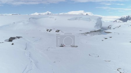 Photo for Antarctica Coast Mountain Expedition Aerial View. Arctic Extreme Cold Weather Island Coastline Snow Covered Surface. People Explore Coastline Drone Flight Zooming Out Timelapse Footage in 4K UHD - Royalty Free Image