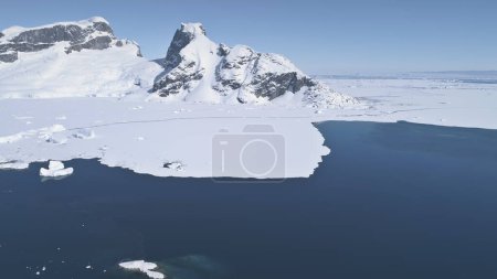 Foto de Aerial Zoom Flight Over Antarctica Ocean To Snow Mountains Land. Escena de invierno. Epic Drone Overview of Ice Cold Antarctic Coast (en inglés). Silvestre. Belleza y fuerza de la naturaleza intacta. Filmación 4k
. - Imagen libre de derechos