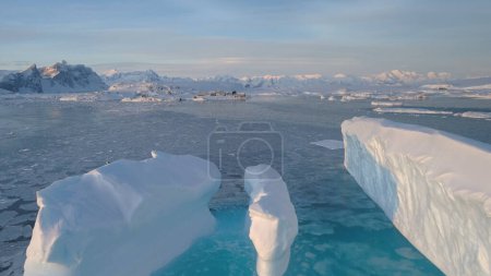 Antarctica Big Iceberg Vernadsky Station Aerial. Arctic Ocean Massive Turquoise Ice Float at Pole Base, Majestic Nature Panorama Top Drone Flight View Footage Shot in 4K UHD