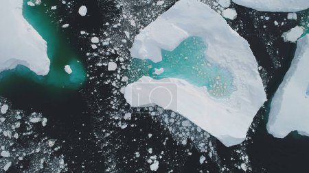 Antarctica Iceberg Turquoise Lake Aerial Top Down View. Big Majestic Blue Ice Glacier Melting in Polar Winter Sea. Climate Change Seascape Drone Flight Footage Shot 4K UHD