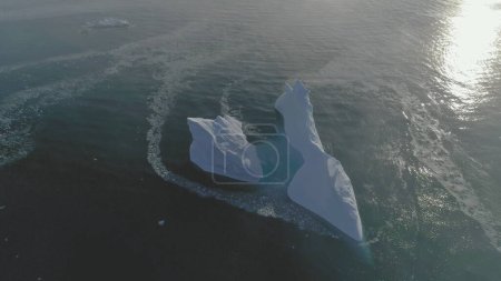 Iceberg Float Open Water Ocean Drone Aerial View. Huge Ice Melt Global Antarctica Climate Change Concept Tracking Flight. Winter Polar Glacier Arctic Seascape Footage Shot in 4K UHD