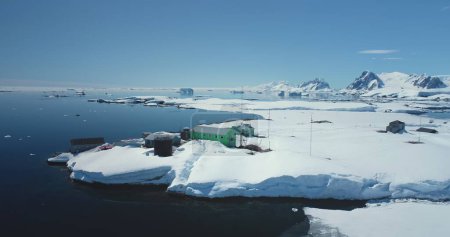 Ukrainian Antarctic research station Vernadsky among wild winter landscape. Expeditions, scientific research and explore on South Pole. Breathtaking harmony of untouched nature. Aerial drone panorama