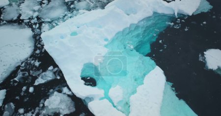 Blue water Antarctica melting glacier float icy ocean. Environment ecological issue of global warming. Polar climate change at winter day. Antarctic cold water ice background. Aerial view drone shot
