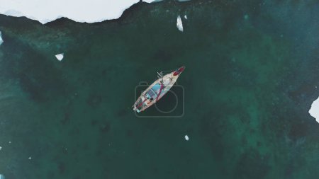 Yacht Sail in Arctic Ocean Aerial Top Down View. Sailing Vessel Explore Polar Nature Chrystal Clear Water for Global Warming Effect Above Drone View